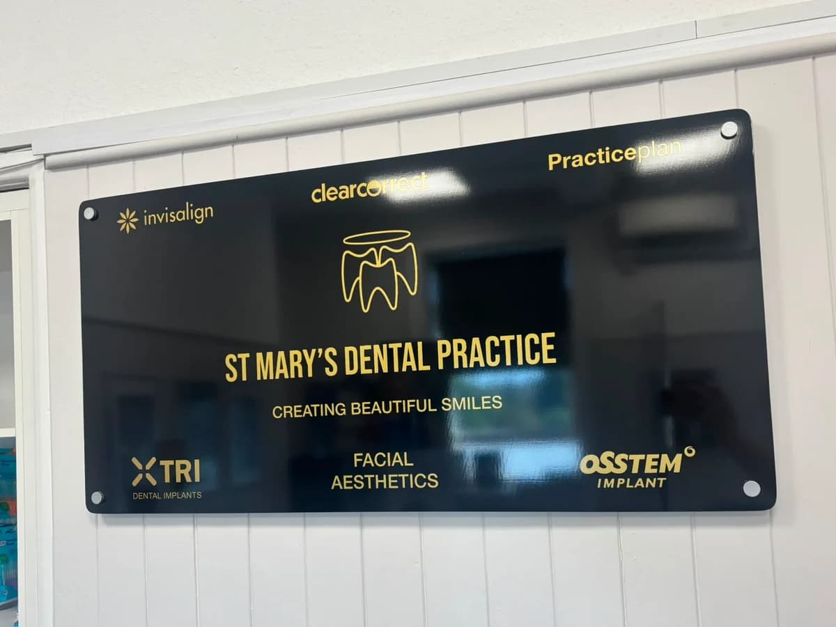 Board at St Mary's Dental Practice reception showing Invisalign, ClearCorrect, Practice Plan, TRI Dental Implants and Osstem Implant